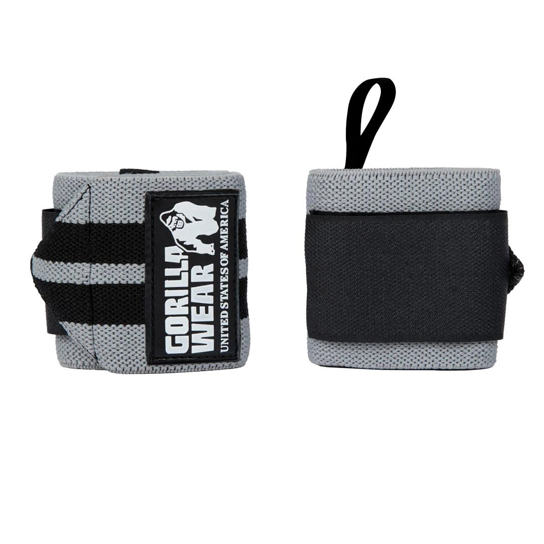 Harmaa-mustat Gorilla Wear Wrist Wraps Pro Black/Gold -rannekääreet peukalolenkillä raskaisiin nostoihin.