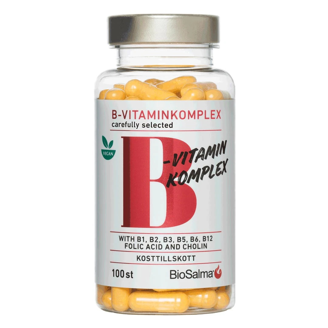 BioSalma B-vitamin Komplex 100 caps läpinäkyvässä purkissa, jossa on hopeakansi, valkoinen etiketti ja keltaiset kapselit., kuva 1/1