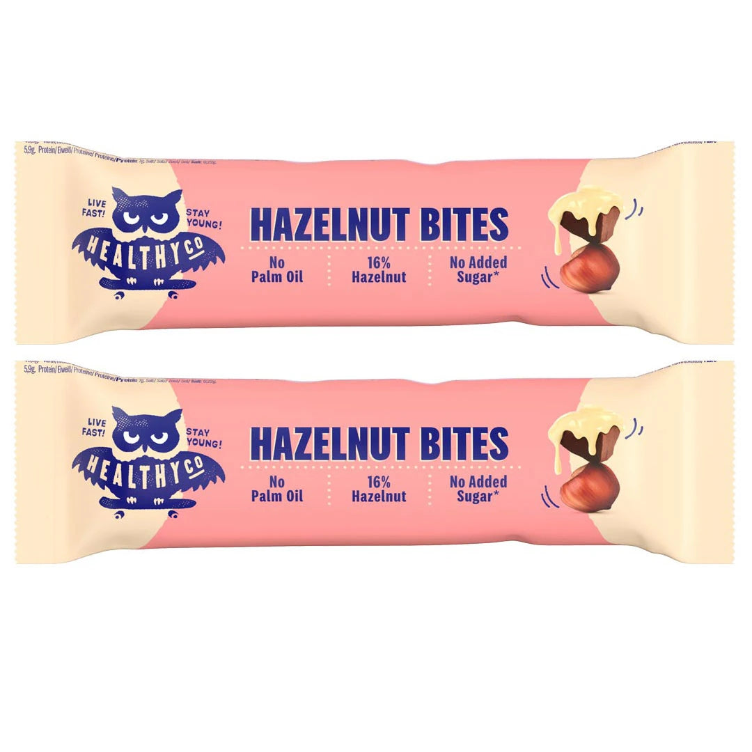 Kaksi vaaleanpunaista Healthyco Hazelnut Bites 21 g x 2 st -pakkausta tummansinisellä tekstillä ja hasselpähkinän kuvalla., kuva 1/1