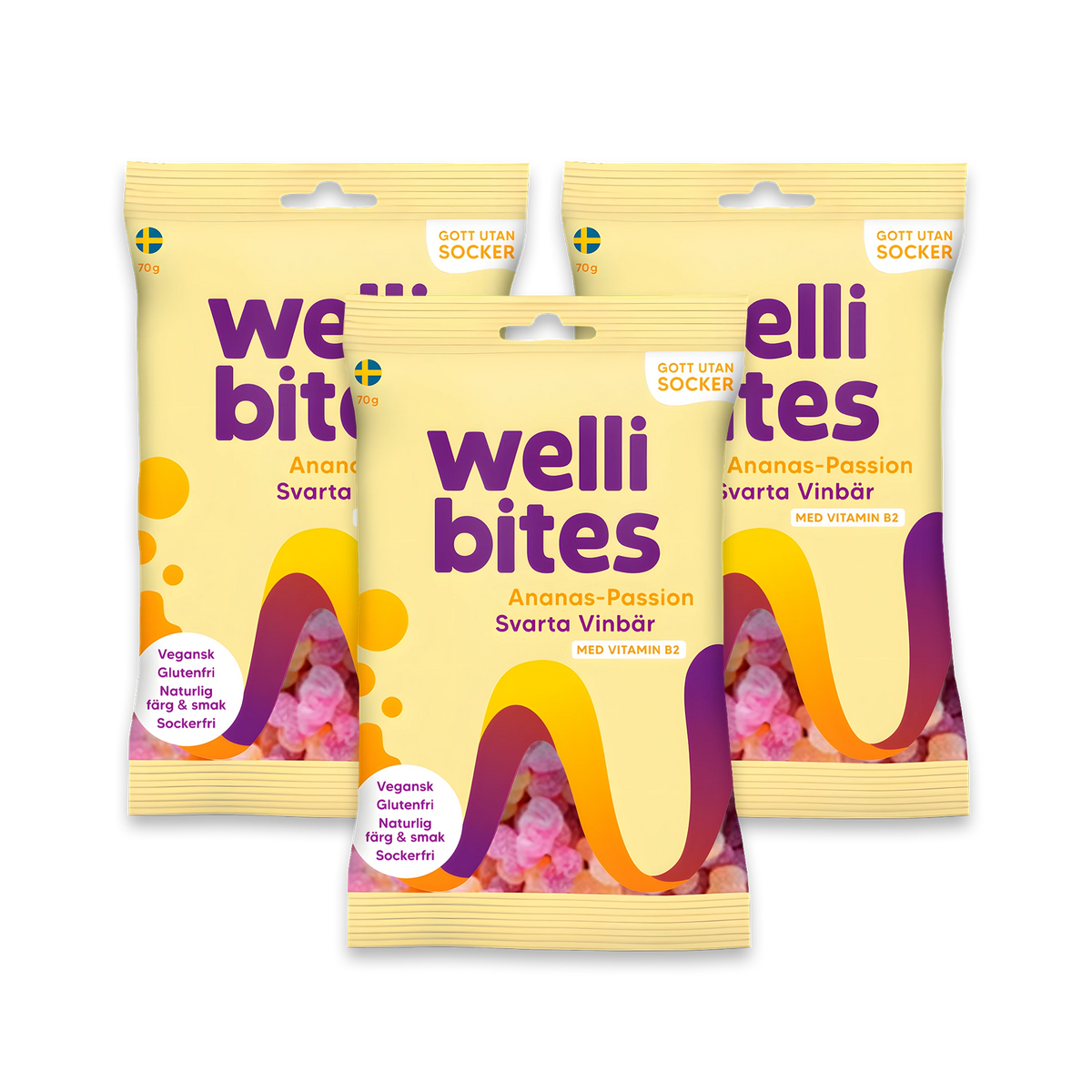 3 x Wellibites Candy 70 g -sokeriton karkki kolmessa keltaisessa pussissa violeteilla ja oransseilla yksityiskohdilla, makuna Ananas-Passion & Mustaherukka.