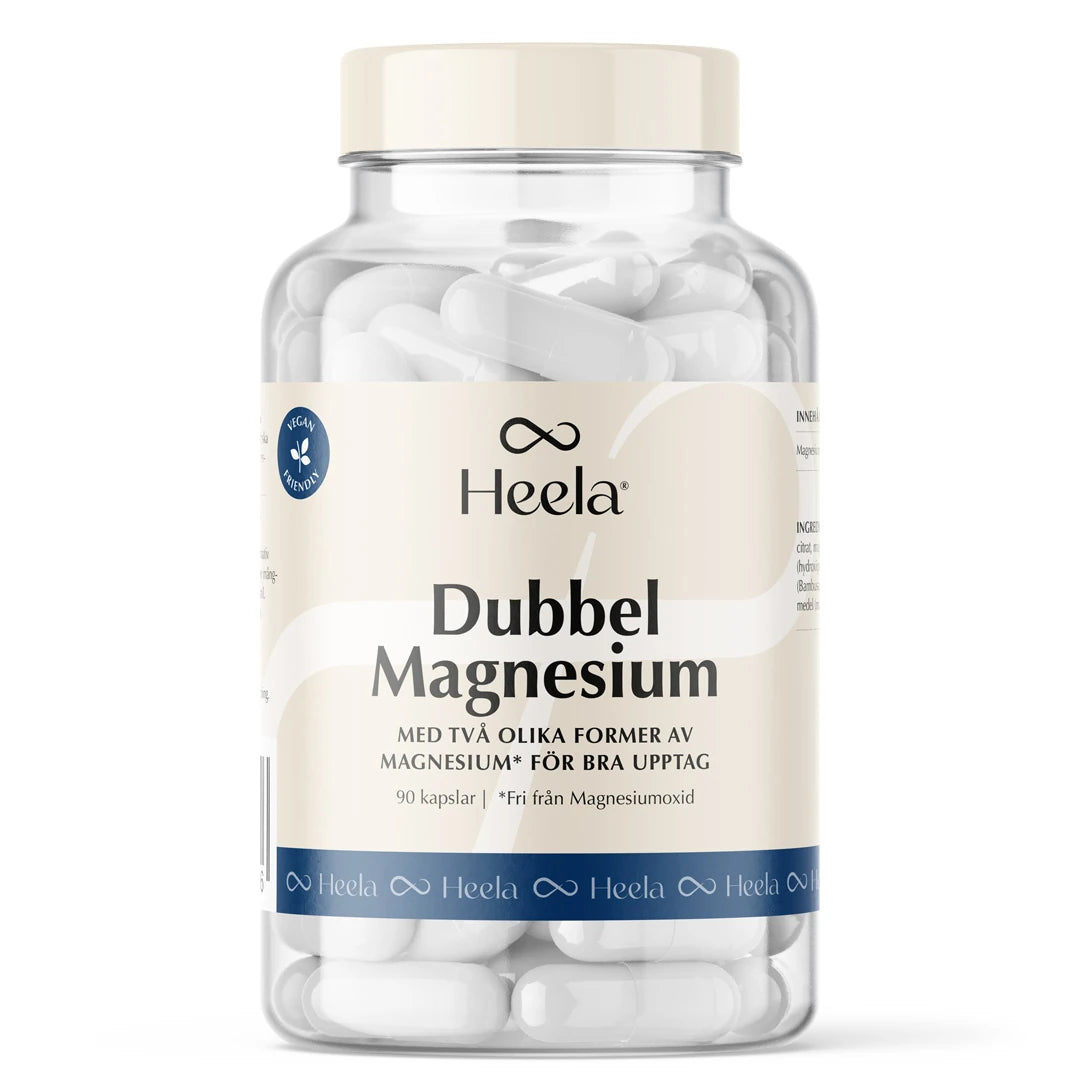 Heela Dubbel Magnesium 90 caps -ravintolisä läpinäkyvässä purkissa vaalealla etiketillä, täynnä valkoisia kapseleita., kuva 1/1