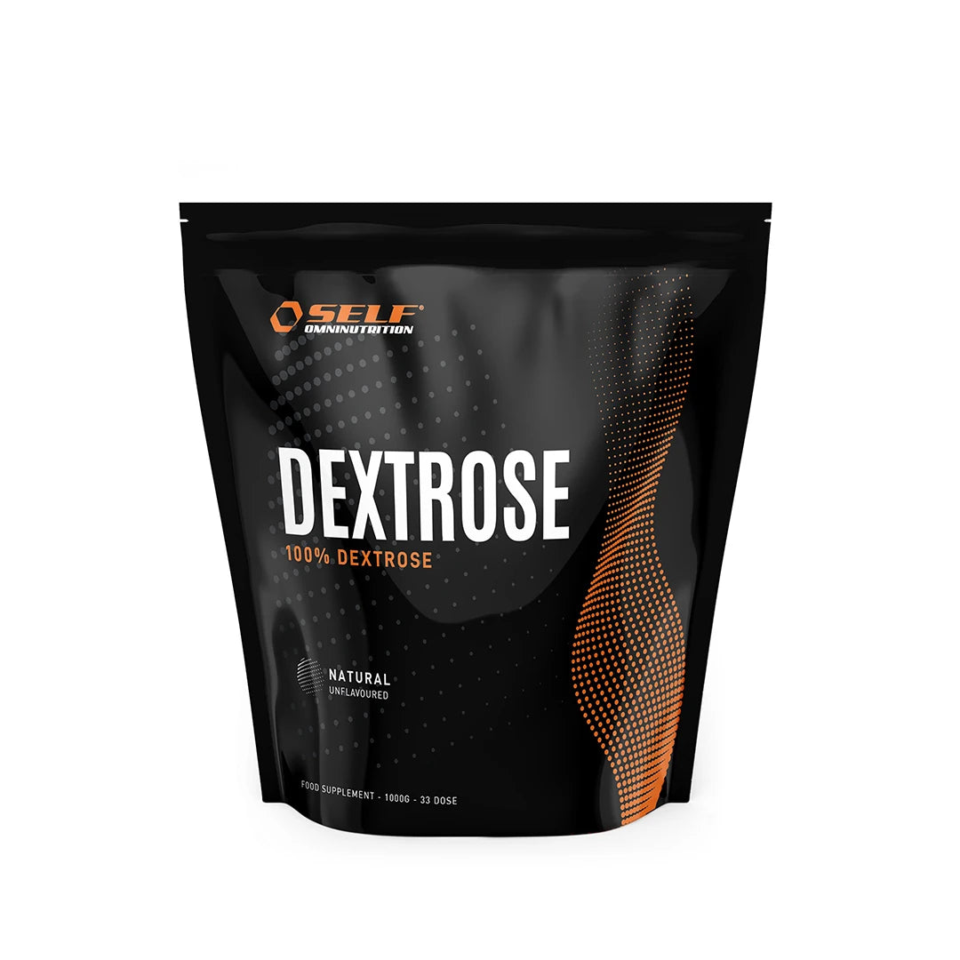 Self Omninutrition Dextrose 1 kg pakattuna mustaan pussiin, jossa on oransseja yksityiskohtia ja tekstiä hiilihydraattituotetyypille., kuva 1/1