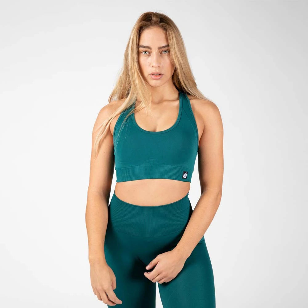 Gorilla Wear Yava Seamless Sport Bra Green, saumaton vihreä urheiluliivi leveällä ribatulla alaresorilla naisen yllä., kuva 1/3