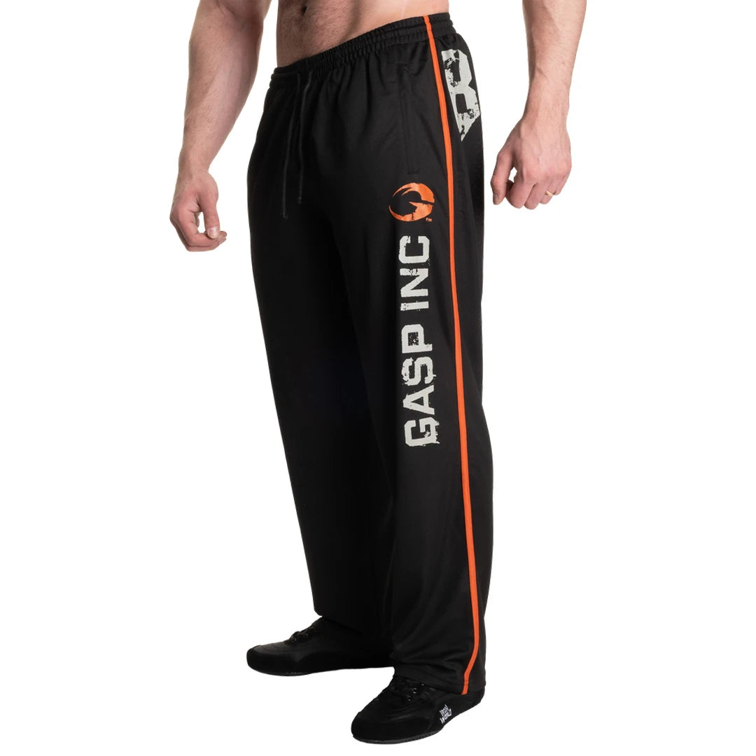 Gasp No 89 Mesh Pants Black -mustat mesh-treenihousut, joissa on oranssi sivuraita ja suuri logopainatus.